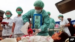 台灣法輪功學員在抗議中模擬中國當局如何摘除法輪功學員身體器官 (資料圖片)