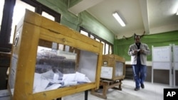 A man prepares to cast his vote during the second day of the parliamentary runoff elections at a polling station in Cairo, December 6, 2011.