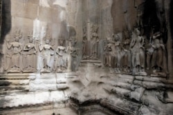 In this July 19, 2012 photo, Apsara sculptures are carved on a wall of the Angkor Wat temple complex in Siem Reap, northwest of Phnom Penh, Cambodia.