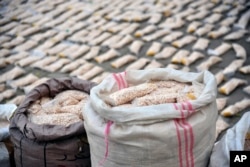 FILE - In this photo released by the Syrian official news agency SANA, Syrian authorities display Captagon pills, in rural Damascus, Syria, Nov. 30, 2021.