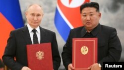 Russia's President Vladimir Putin and North Korea's leader Kim Jong Un pose for a photo during a signing ceremony following bilateral talks in Pyongyang, North Korea, June 19, 2024. (Sputnik/Kristina Kormilitsyna/Kremlin via Reuters)