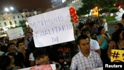 Miembros de organizaciones de homosexuales y lesbianas sostienen carteles mientras marchan en apoyo del proyecto de ley de Unión Civil en Lima, 2 de marzo de 2015.