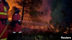 FILE - Firefighters battle flames from the Villanueva de Viver wildfire in Spain, March 23, 2023. (Military Emergency Unit via Reuters)