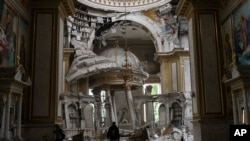 Church personnel inspect damage inside the Transfiguration Cathedral in Odesa, Ukraine, July 23, 2023, following Russian missile attacks.