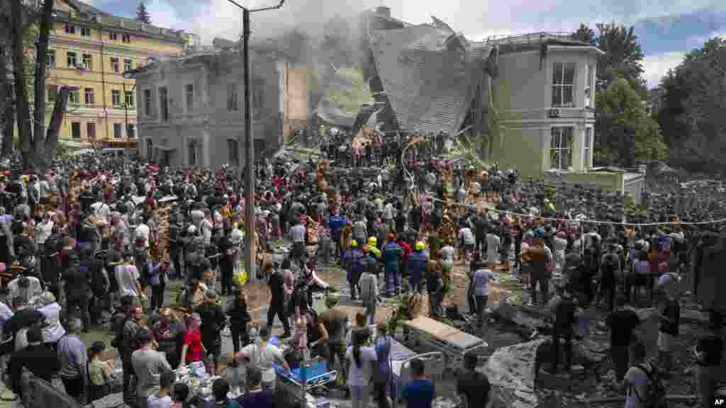 Rescuers and volunteers clean up the rubble and search victims after Russian missile hit the country's main children hospital Okhmatdyt during massive missile attack on many Ukrainian cities in Kyiv, Ukraine.
