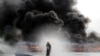 A firefighter sprays water to control the burning of seized illegal drugs during a destruction ceremony to mark the U.N.'s "International Day against Drug Abuse and Illicit Trafficking" in Yangon, Myanmar, June 26, 2024.