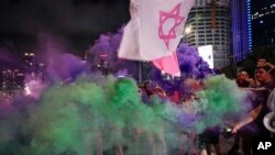 Demonstrators block a highway during a protest against plans by Prime Minister Benjamin Netanyahu's government to overhaul the judicial system, in Tel Aviv, Israel, July 8, 2023.