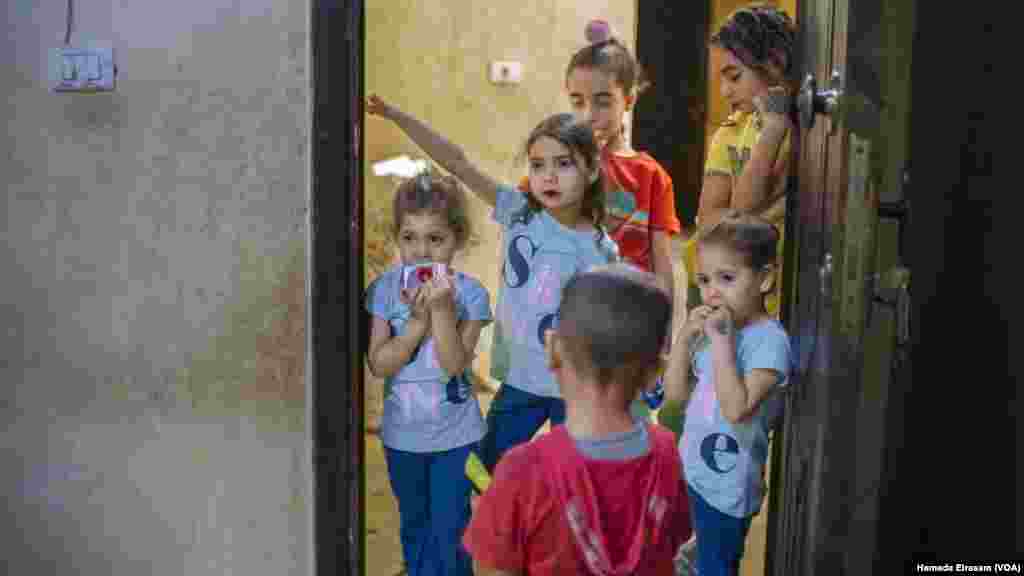 Ahead of Eid celebrations, young siblings visit their neighbors as part of a holiday custom in Egypt among children, who are also traditionally gifted a new set of clothes for the occasion. 