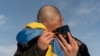 FILE - A recently swapped Ukrainian prisoner of war cries while calling his relatives after a prisoner exchange on the Ukraine-Russia border on Jan. 31, 2024. 