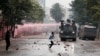 Riot police vehicles disperse protesters during an anti-government demonstration following nationwide deadly riots over tax hikes and a controversial now-withdrawn finance bill, in Nairobi, Kenya, July 16, 2024.