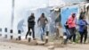 Supporters of Kenya's opposition leader Raila Odinga run after riot police officers lobbed teargas to disperse them during an anti-government protest in Nairobi, Kenya July 7, 2023.