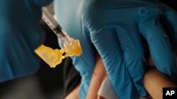 FILE - A nurse administers a Moderna COVID-19 booster vaccine in Jackson, Mississippi, Nov. 18, 2022. This week, U.S. regulators cleared another COVID-19 booster dose for older adults and people with weak immune systems.