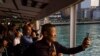 Mainland Chinese tourists ride the Star Ferry in Hong Kong, April 12, 2023. 