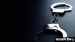 Police metal handcuffs on black background, close-up, selective focus