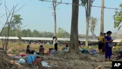 Residents from eastern Myanmar are seen after fleeing into Thailand's Tak Province from Myanmar's Myawaddy district, Thursday, April 6, 2023. More than 5,000 people have fled from eastern Myanmar into Thailand. (AP Photo/Chiravuth Rungjamratratsami)