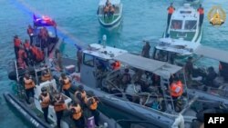 FILE - This frame grab from a handout video taken on June 17, 2024, shows China coast guard boats, left, approaching Philippine boats, center, during an incident off Second Thomas Shoal. (Armed Forces of the Philippines - Public Affairs Office/AFP)