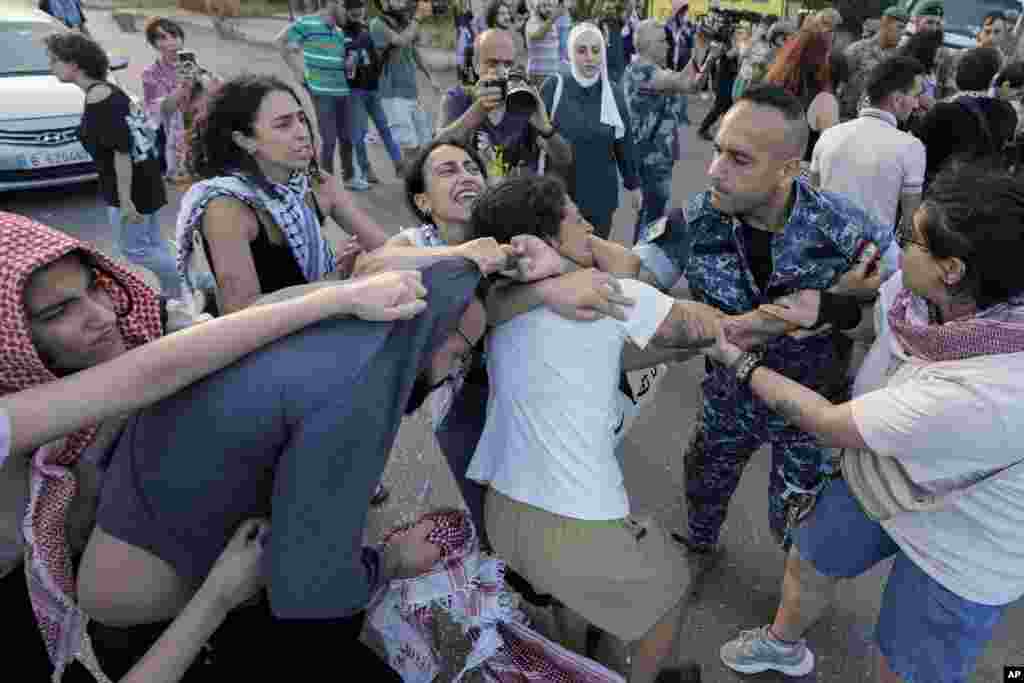 Protesters clash with riot police during a demonstration near the Egyptian embassy in Beirut, Lebanon, in solidarity with the Palestinian people in Gaza and demanding the Egyptian authorities open the Rafah border crossing between Egypt and the Gaza Strip. 