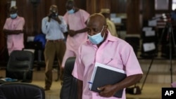FILE - Paul Rusesabagina, who inspired the film 'Hotel Rwanda' and is credited with saving more than 1,000 people by sheltering them at the hotel he managed during the genocide, attends a court hearing in Kigali, Rwanda, Feb. 26, 2021. 