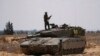 Israeli soldiers are seen near the border with the Gaza Strip, in southern Israel, May 7, 2024.