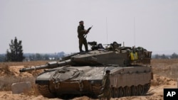 Israeli soldiers are seen near the border with the Gaza Strip, in southern Israel, May 7, 2024.