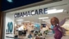 FILE - An insurance agent talks with clients inside the main location of Las Madrinas de los Seguros, Spanish for "The Godmothers of Insurance," at a shopping center in Miami, on Dec. 5, 2023. 