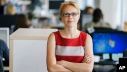 FILE - Maryna Zolatava, chief editor of the Belarus' news outlet Tut.by, which was closed by authorities, poses for a photo in Minsk, Belarus, Aug. 28, 2015.