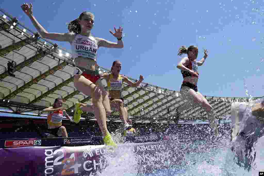 Zita Urban of Hungary, left,competes in a women's 3000 meters steeplechase heat at the European Athletics Championships in Rome.