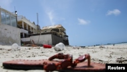 An abandoned shoe lies at the scene of an explosion that occurred while revelers were swimming at the Lido beach in Mogadishu, Somalia, Aug. 3, 2024.