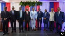 FILE - Haiti's transitional presidential council members pose for a group photo in Port-au-Prince, Haiti, April 30, 2024. Louis Gerald Gilles is pictured on the right. Smith Augustin is third from right and Emmanuel Vertilaire is fourth from right. 