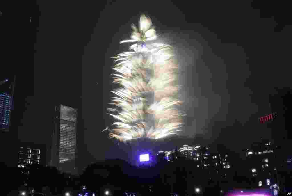 Fireworks explode from the Taipei 101 building during the New Year's celebrations in Taipei, Taiwan, Jan. 1, 2024.