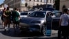 Sejumlah pengunjung memperhatikan mobil listrik buatan produsen China BYD di sebuah pameran motor di Munich, Jerman, 3 September 2023. (Foto: Matthias Schrader/AP Photo)