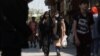 Iranian women walk on a street amid the implementation of the hijab surveillance in Tehran, Iran, April 15, 2023. Majid Asgaripour/West Asia News Agency via Reuters