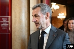 Former French President Nicolas Sarkozy leaves the courthouse after the ruling in his appeal trial in a corruption case at Paris courthouse on May 17, 2023.