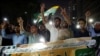 People hold a banner in support of an alliance of civil rights groups protesting in Pakistan-ruled Kashmir, demanding the government give the region a subsidy on electricity and wheat prices, during a demonstration in Karachi, May 13, 2024. 