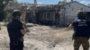 In this handout photograph taken and released by the Office of the Prosecutor General of Ukraine on Aug. 26, 2023, war crime prosecutors work at the site of a shelling in the village of Podoly near Kupiansk, Kharkiv region.