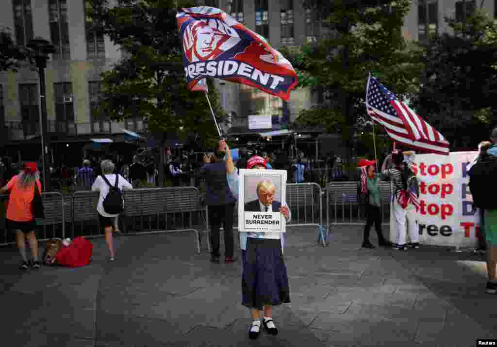 A supporter of former U.S. President Donald Trump waves a flag outside the Manhattan criminal court during jury deliberations in his hush money trial in New York City.