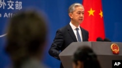 FILE - Chinese Foreign Ministry spokesperson Wang Wenbin, who is China’s new ambassador to Cambodia, speaks during a press conference in Beijing, May 9, 2023. 