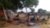 FILE - Residents displaced by violent attacks squat on blankets in the village of Masteri in west Darfur, Sudan, on July 30, 2020. Malnutrition and disease have killed at least 1,200 children under the age of five since May 2023 across nine camps in Sudan, the U.N. reports.