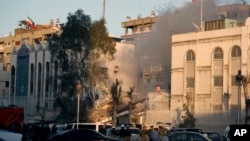 Emergency services work at a destroyed building hit by an airstrike in Damascus, Syria, April 1, 2024. The airstrike, widely attributed to Israel, destroyed the consular section of Iran's embassy in Damascus, killing 12 people. 