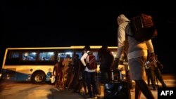 Fleeing Nigerian students prepare to enter a shuttle after being evacuated from Sudan to Nigeria at the Nnamdi Azikwe International Airport in Abuja, Nigeria, May 4, 2023.