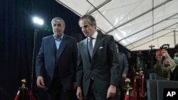 Mohammad Eslami, who heads the Atomic Energy Organization of Iran, left, and Rafael Mariano Grossi, who heads the International Atomic Energy Organization, arrive for a joint press conference in Tehran, Iran, March 4, 2023.