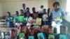 Vana vepa Dekezi Primary School vachiratidza mabhuku avakapihwa neRural Schools Library Trust