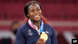 FILE - Clarisse Agbegnenou of France celebrates with her gold medal for the women's under 63kg judo match at the Summer Olympics in Tokyo, July 27, 2021.
