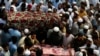 Relatives and mourners gather around the caskets of victims who were killed in Sunday's suicide bomber attack in the Bajur district of Khyber Pakhtunkhwa, Pakistan, July 31, 2023.