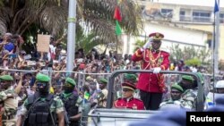 FILE - Gabon coup leader General Brice Oligui Nguema waves after being sworn in as interim president during his swearing-in ceremony, in Libreville, Gabon, Sept. 4, 2023.