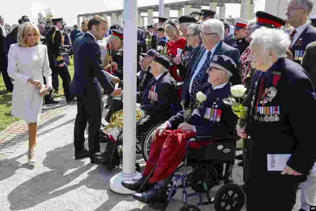 French President's wife Brigitte Macron, French President Emmanuel Macron and Britain's King Charles III, rear, meet British D-Day veterans during a commemorative ceremony marking the 80th anniversary of the World War II D-Day Allied landings in Normandy, at the World War II British Normandy Memorial of Ver-sur-Mer.