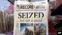 A stack of the latest weekly edition of the Marion County Record sits in the back of the newspaper's building, awaiting unbundling, sorting and distribution, Aug. 16, 2023, in Marion, Kan.
