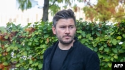 FILE - Russian author Dmitry Glukhovsky poses for a photograph Oct. 21, 2022, in Frankfurt am Main, Germany. A Russian court sentenced the writer to eight years in prison in absentia for denouncing Moscow's Ukraine offensive. 