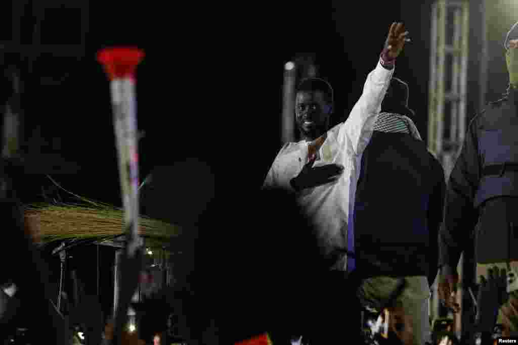 Senegalese presidential candidate Bassirou Diomaye Faye cheers supporters up during his final campaign rally in Mbour, March 22, 2024.
