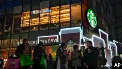 资料照片：2023年12月23日，北京一条商业街上的星巴克咖啡店。（美联社照片）